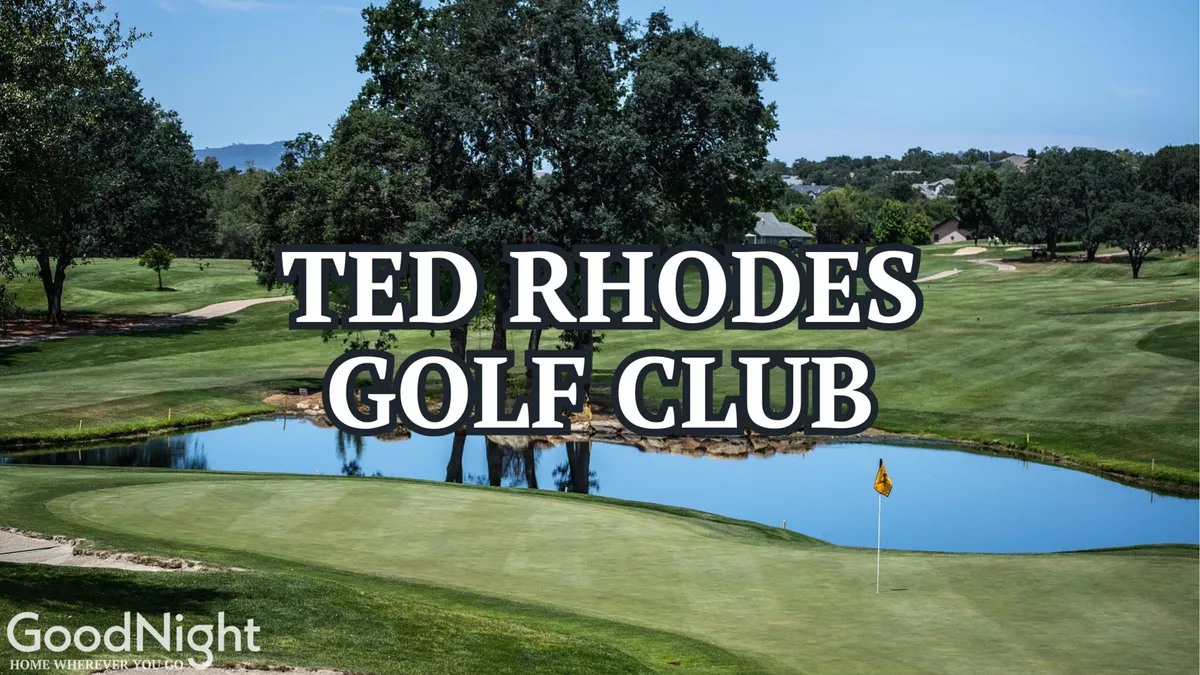 A lush golf green framed by a tranquil water feature and mature trees, with a flagstick marking the hole. The scene exudes a relaxed outdoor atmosphere ideal for golf enthusiasts.